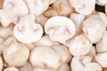 Fototapeta na wymiar Raw sliced cultivated button mushrooms, top view close-up