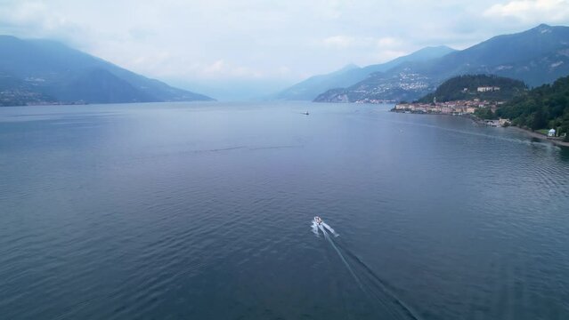 Speed boat on beautiful Lake Como near Bellagio, drone flyover.