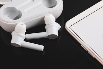 Wireless ear buds or headphone with smartphone. technology concept.