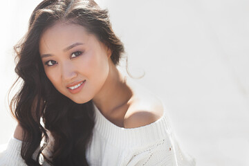 Fototapeta premium Beautiful woman outdoors. Pretty lady on urban background. Asian female closeup portrait.