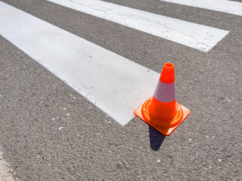 Zebra crossing marking paint and orange cone