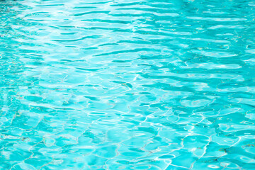 Ripple Water in swimming pool with blue tile floor background