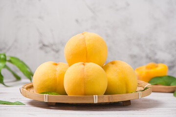 fresh ripe yellow peaches on wooden table