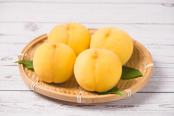 fresh ripe yellow peaches on wooden table