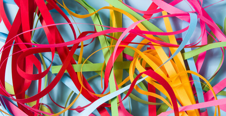 Chaotic colorful paper tapes, tangled Curves random stripes background.