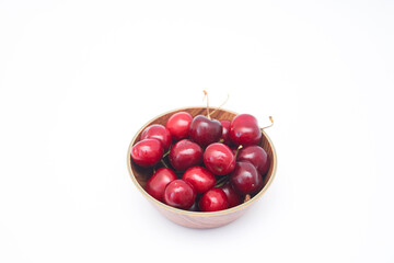 Cherry berries in bowl on a white background