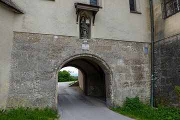 Fototapeta na wymiar Old passageway with the statue of Saint Erentrude above in Salzburg, Austria