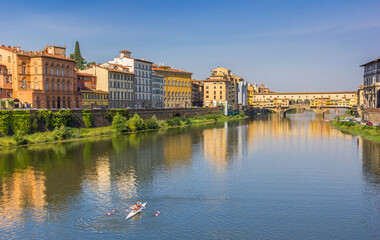Rowing boat on the river Arno in Florence, Italy - obrazy, fototapety, plakaty