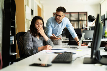 Colleagues arguing in office. Angry businessman yelling at his collegue.