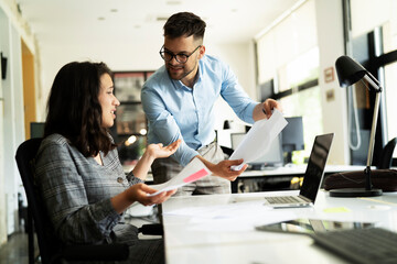 Fototapeta premium Colleagues arguing in office. Angry businessman yelling at his collegue.