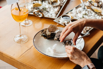 Female hands holding pizza Four Cheeses with cheddar, Parmesan, mozzarella on a dark background, . food delivery, place for text, vertical image