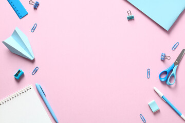 Back to school concept. Flat lay blue school supplies on pink table. Creative layout.