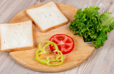 Many ingredients to make a sandwich on wooden desk