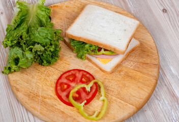 Many ingredients to make a sandwich on wooden desk