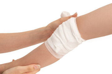 Caring mother wounded bandage around little's boy injured leg after accident.