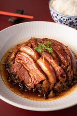 Braised Pork Belly with Preserved Mustard Green on with rice red background