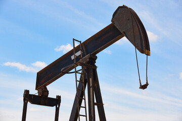 Oil pumping machine. Pump jack. Petroleum extraction. Global warming. Backlight