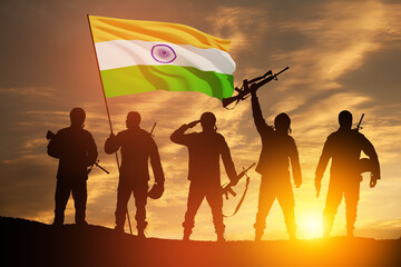 Silhouettes of soldiers with India flag on a background the sunset or the sunrise. Greeting card...