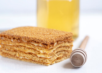 Slice of homemade honey cake on white background.