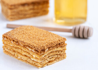Fototapeta na wymiar Slice of homemade honey cake on white background.