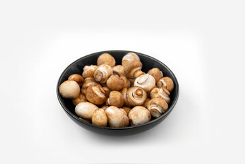mushrooms champignon in  bowl on white background