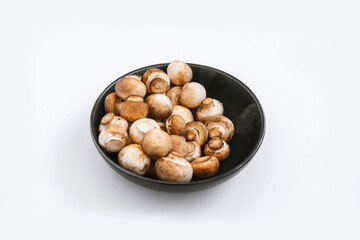 mushrooms champignon in  bowl on white background