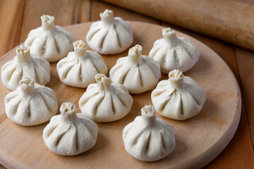 Georgian homemade food called khinkali. Georgian cuisine. On the old wooden background.