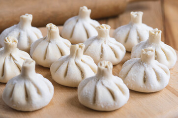 Georgian homemade food called khinkali. Georgian cuisine. On the old wooden background.