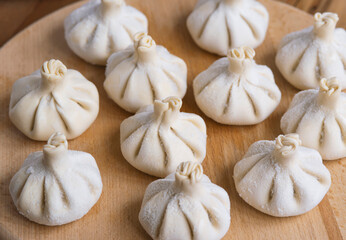 Georgian homemade food called khinkali. Georgian cuisine. On the old wooden background.
