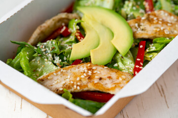 Healthy chicken salad with avocado,in package for take away or food delivery.