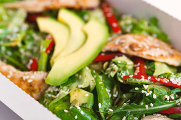 Healthy chicken salad with avocado,in package for take away or food delivery.