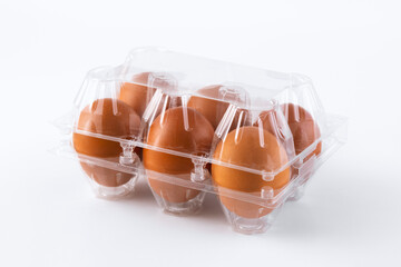 Fototapeta na wymiar Brown chicken eggs in a plastic package on white background.6 pieces brown eggs.