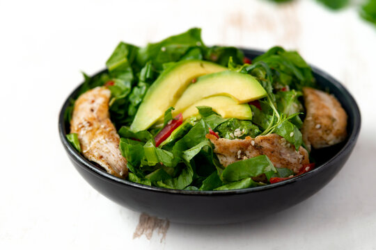 Chicken Salad With Avocado In A Black Bowl. Healthy Food