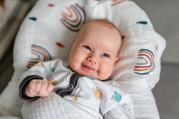 A two-month-old baby is lying, a cute portrait of a Caucasian newborn