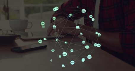 Image of globe with network of connections with digital icons over man using tablet