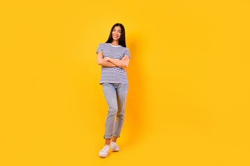 Fototapeta na wymiar Photo of charming stunning girl dressed striped clothes arms crossed empty space isolated yellow color background