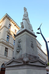 Fototapeta premium The ancient Nereids fountain on the Ferenciek square in the old town of Budapest, Hungary, Eastern Europe. Nymphs, one with a jar on top of her head, beautiful mythological stone figures.