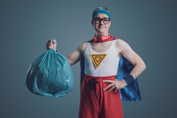 Ecology superhero holding a trash bag