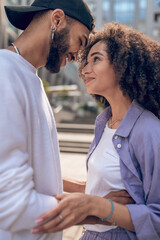 Happy couple in the street looking in love and exited
