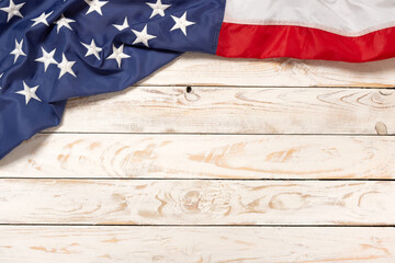 Flat lay USA flag on white wooden board, vintage background with copy space top view. Banner, minimalism. American