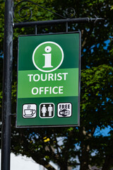 Tourist office sign with coffee, toilets and free wifi symbols.