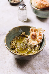 Babaganush or eggplant hummus from baked eggplant. Turkish eggplant dip baba ghanoush served with olive oil, pepper and oriental flatbreads. Selective focus