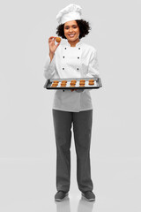 cooking, culinary and bakery concept - happy smiling female chef or baker in white toque and jacket...