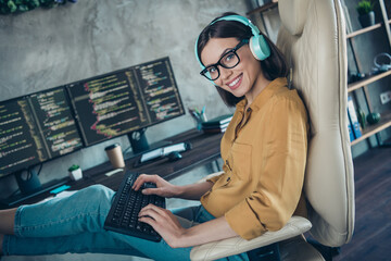 Profile side view portrait of attractive cheery girl editing network intranet interface operating system at workplace workstation indoors