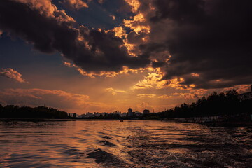 colorful dramatic sky with clouds, smoking cumulonimbus clouds reflect the golden light of the dawn...