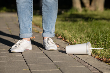 Obraz premium a used cocktail glass lies under a person's feet