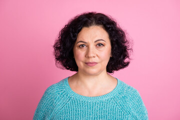 Fototapeta premium Portrait of nice charming aged concentrated woman with serious expression standing over pastel color background