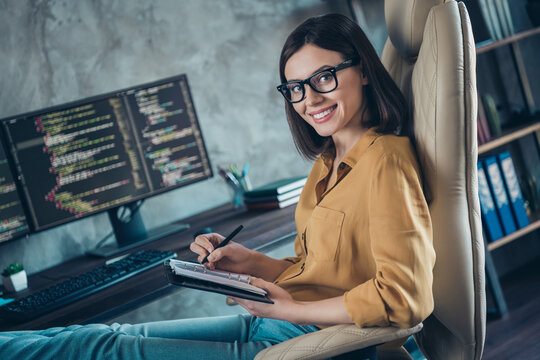 Profile side view portrait of attractive cheerful girl writing data html java developing web startup at workplace workstation indoors