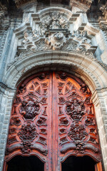 Facade detail and entry door at Metropolitan Cathedral in Zocalo, Center of Mexico City, Mexico. This grand Roman Catholic cathedral with many ornate chapels is Latin America's oldest and largest.