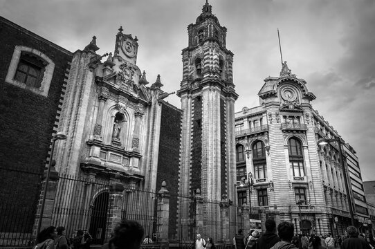 Interesting historic buildings in black and white on 5th Avenue in the historic centre near Zocalo Square, a pedestrian street in Mexico City, Mexico.